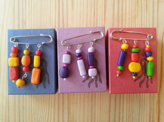 Brooches with handmade beads in various colours